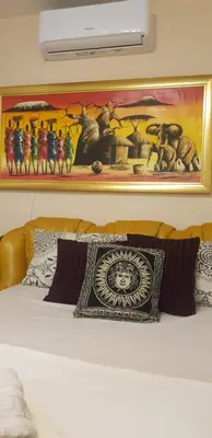 a painting above a bed in a room at Narnia in Belgrade