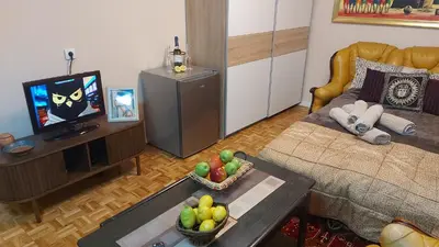 a living room with a couch and a tv at Narnia in Belgrade