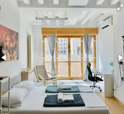 a bedroom with a bed with a desk and chairs at Belgrade Central 532- Obilicev Venac in Belgrade