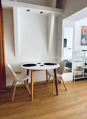 a table and two chairs in a room with a bed at Belgrade Central 532- Obilicev Venac in Belgrade