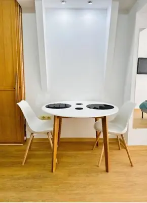 a white table and chairs in a room at Belgrade Central 532- Obilicev Venac in Belgrade