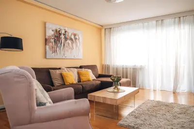 a living room with a couch and a coffee table at Crown Central three bedroom Apartment in Belgrade