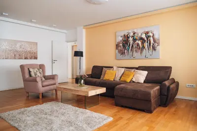a living room with a couch and a table at Crown Central three bedroom Apartment in Belgrade