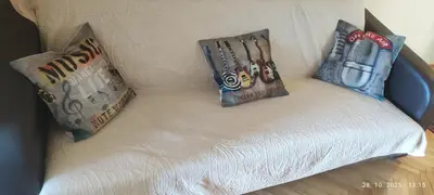 a couch with two pillows on top of it at Genex Gate in Belgrade