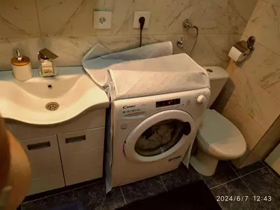 a bathroom with a washing machine and a sink at Genex Gate in Belgrade