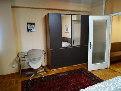 a bedroom with a desk and a chair and a mirror at Genex Gate in Belgrade