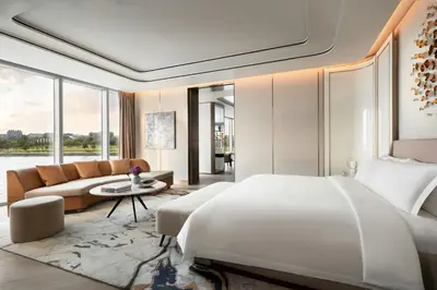 a bedroom with a large bed and a couch at The St. Regis Belgrade in Belgrade