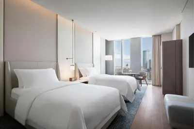 two beds in a hotel room with a view at The St. Regis Belgrade in Belgrade