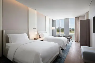 a hotel room with two beds and a table at The St. Regis Belgrade in Belgrade