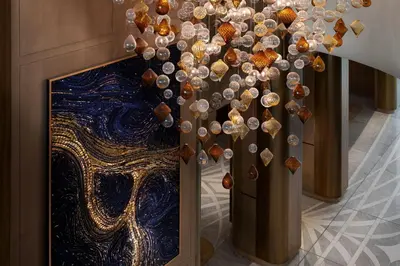 a chandelier with shells on it in a room at The St. Regis Belgrade in Belgrade