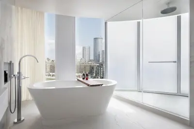 a white bathroom with a tub and a window at The St. Regis Belgrade in Belgrade
