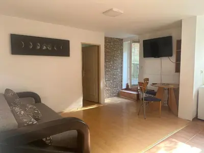 a living room with a couch and a table at Apartment GreenTerrace next to TC BIG FASHION Mall in Karaburma