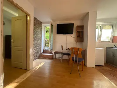 a kitchen and dining room with a table and chairs at Apartment GreenTerrace next to TC BIG FASHION Mall in Karaburma