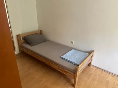 a small bedroom with a bed in a room at Apartment GreenTerrace next to TC BIG FASHION Mall in Karaburma