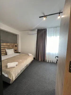 a bedroom with a bed and a window at Sremsky inn in Stara Pazova