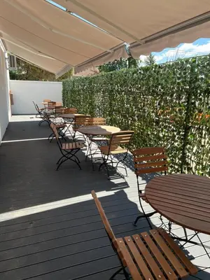 a row of tables and chairs on a patio at Sremsky inn in Stara Pazova