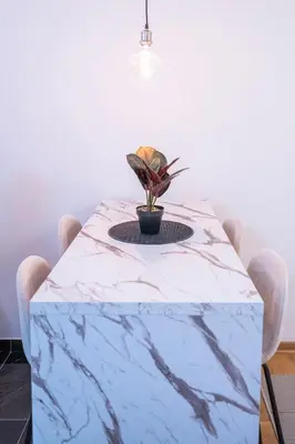 a blue marble table with a plant on top of it at Andrej Lux in Jajinci