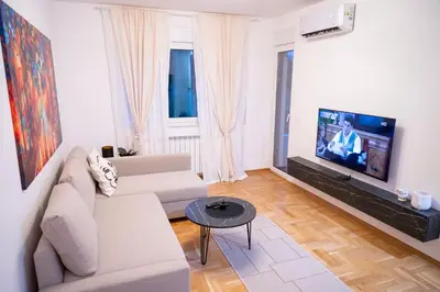 a living room with a couch and a tv at Andrej Lux in Jajinci