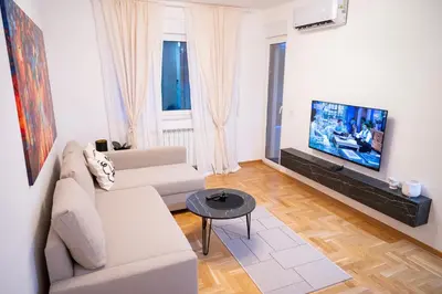 a living room with a couch and a flat screen tv at Andrej Lux in Jajinci