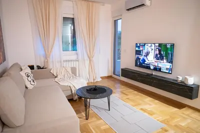 a living room with a couch and a flat screen tv at Andrej Lux in Jajinci