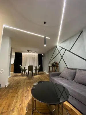 a living room with a couch and a table at 87m2 Blok24 Arena Business in Belgrade