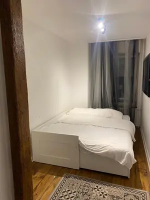 a white bed in a room with a window at 87m2 Blok24 Arena Business in Belgrade