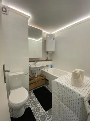 a white bathroom with a toilet and a sink at 87m2 Blok24 Arena Business in Belgrade
