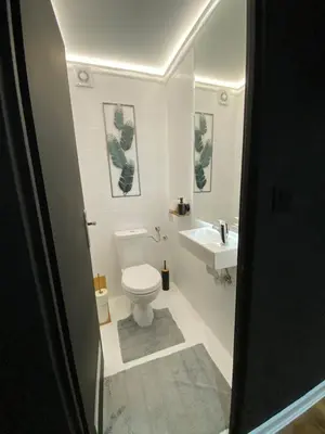 a bathroom with a toilet and a sink at 87m2 Blok24 Arena Business in Belgrade