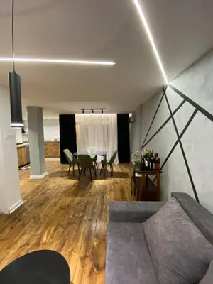 a living room with a couch and a table at 87m2 Blok24 Arena Business in Belgrade