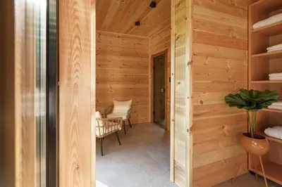 a room with wood paneling and a hallway at Espacio Resort - Pool & Spa in Novi Vladimirovac