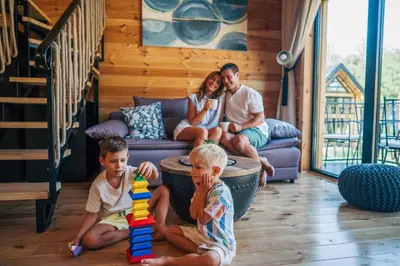 a family playing with a toy in a living room at Espacio Resort - Pool & Spa in Novi Vladimirovac