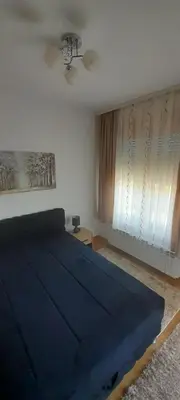 a bedroom with a blue bed in a room at Elegance in Zemun