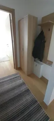 a living room with a door open to a room at Elegance in Zemun