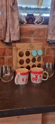two coffee cups sitting on a counter next to a box at NaVisu avlija in Kruševica