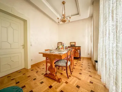 a dining room with a wooden table and a chandelier at Djuras residence in the center of Belgrade in Belgrade