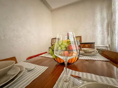 a table with a wine glass and a bowl of fruit at Djuras residence in the center of Belgrade in Belgrade