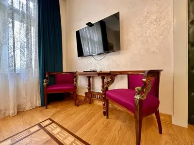 a room with two chairs and a desk with a television at Djuras residence in the center of Belgrade in Belgrade