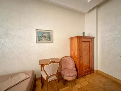 a bedroom with a table and a chair and a cabinet at Djuras residence in the center of Belgrade in Belgrade