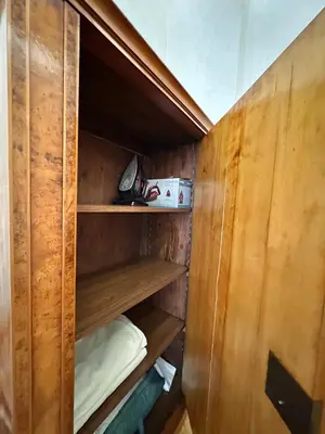 a closet with wooden walls and shelves in a room at Djuras residence in the center of Belgrade in Belgrade