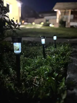 a row of parking meters in the grass at night at Čajića avlija in Obrenovac
