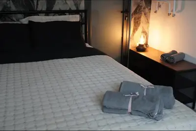a bedroom with a bed with two bags on it at Soffito studio in Belgrade