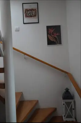 a staircase with two pictures on the wall and a picture on the wall at Soffito studio in Belgrade