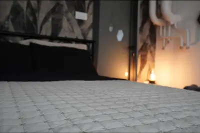 a bedroom with a bed with a black and white mattress at Soffito studio in Belgrade