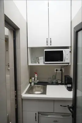 a small kitchen with a sink and a microwave at Soffito studio in Belgrade