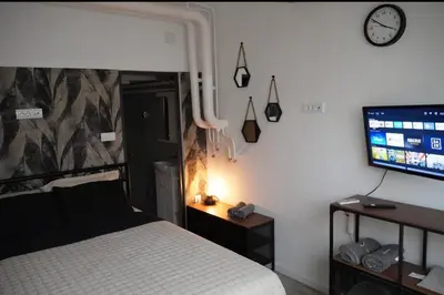 a bedroom with a bed and a flat screen tv at Soffito studio in Belgrade