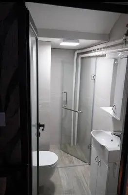 a bathroom with a shower and a toilet and a sink at Soffito studio in Belgrade