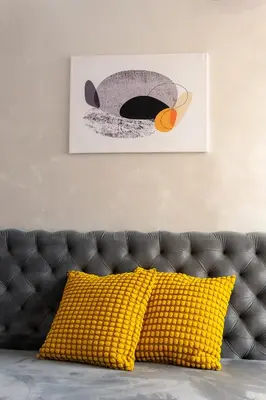 a couch with a yellow pillow in a living room at Valia apartments in Belgrade
