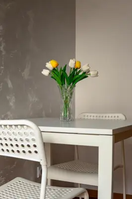 a vase of flowers sitting on a table at Valia apartments in Belgrade