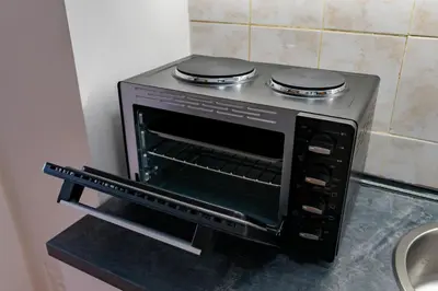a black oven with two burners on top of it at Valia apartments in Belgrade