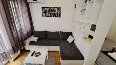 a small living room with a couch and a table at Maya 's home - Vracar in Vračar (historical)